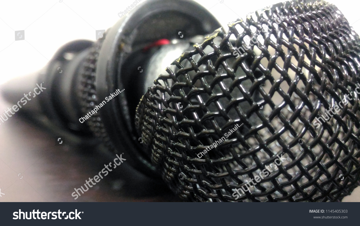 stock-photo-a-broken-microphone-on-the-table-spot-focus-1145405303